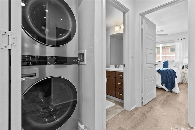 91-1081 Iwikuamoo St Unit 1203, Ewa Beach, HI 96706 - laundry room with stacked washer / dryer and light wood finished floors