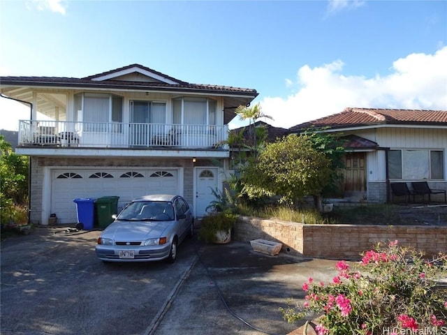 view of front facade with a balcony and a garage