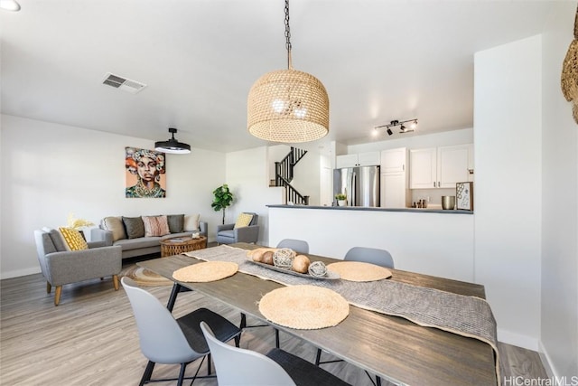 dining space with light hardwood / wood-style floors