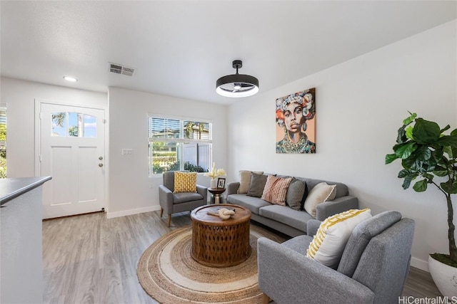 living room with light hardwood / wood-style flooring