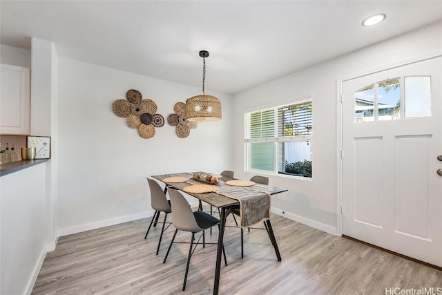 dining space with light hardwood / wood-style flooring