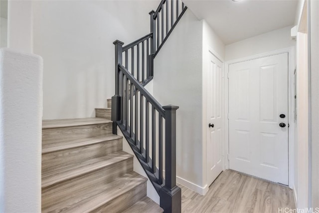 staircase featuring wood-type flooring