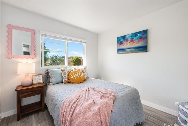 bedroom with dark hardwood / wood-style flooring