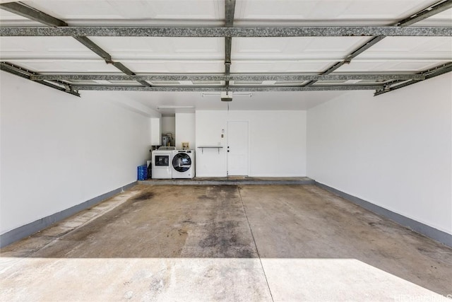 garage featuring washing machine and clothes dryer and a garage door opener