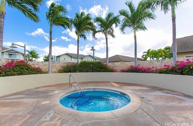 view of pool with a hot tub and a patio area