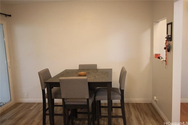 dining room with dark hardwood / wood-style flooring