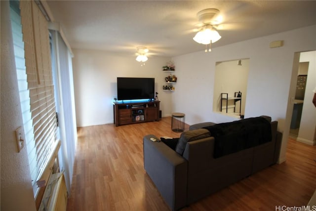 living room featuring ceiling fan and wood-type flooring