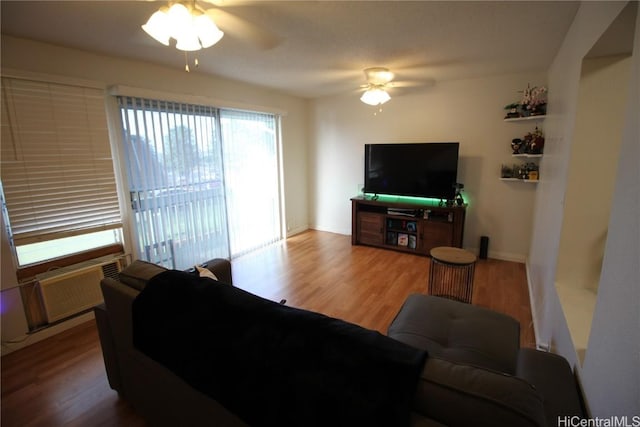 living room with hardwood / wood-style flooring and ceiling fan