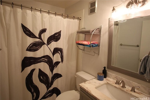 bathroom featuring vanity, toilet, and a shower with shower curtain