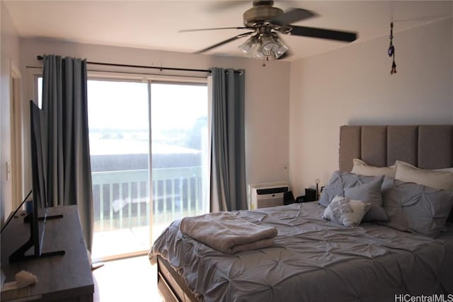 bedroom featuring ceiling fan, a wall mounted air conditioner, and access to exterior