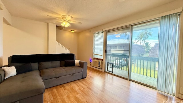 98-271 Kaonohi St Unit H2, Aiea, HI 96701 - living room with cooling unit, ceiling fan, light hardwood / wood-style flooring, and a textured ceiling