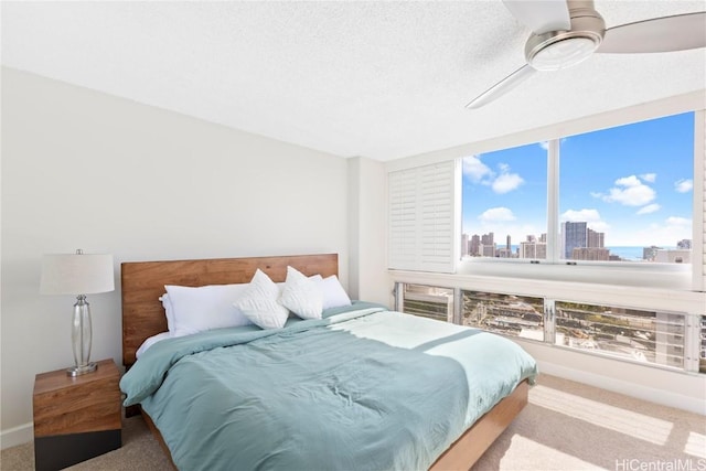 carpeted bedroom with a textured ceiling and ceiling fan