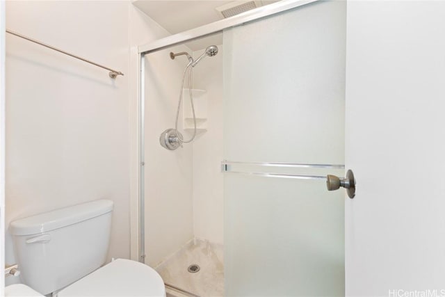 bathroom with toilet and walk in shower