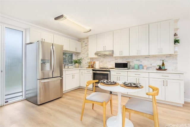 kitchen featuring white cabinetry, stainless steel appliances, and light wood-type flooring