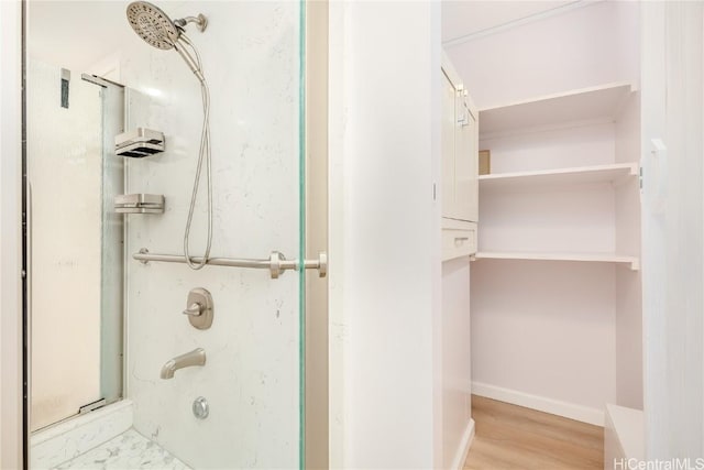 bathroom with wood-type flooring and shower / bathtub combination