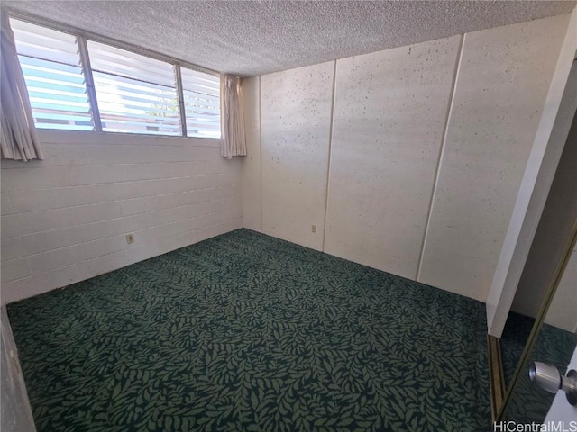 unfurnished room featuring a textured ceiling