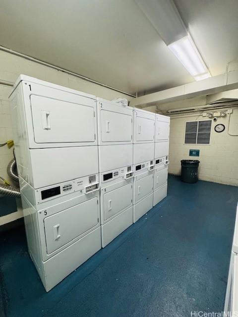 laundry area with stacked washing maching and dryer