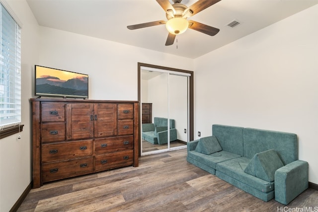 sitting room with ceiling fan and hardwood / wood-style flooring