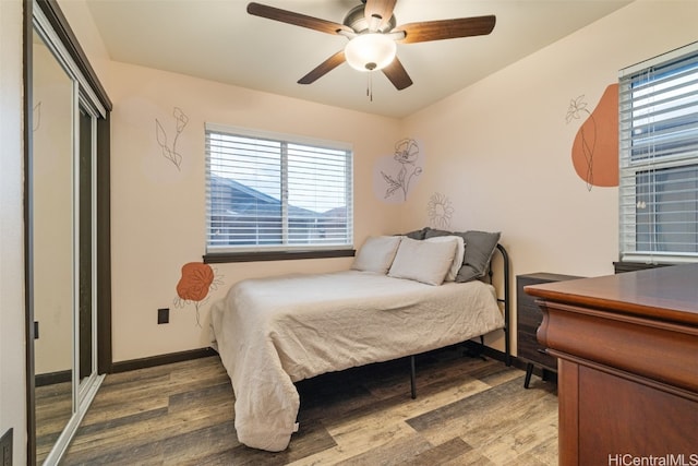 bedroom with a closet, ceiling fan, and wood-type flooring