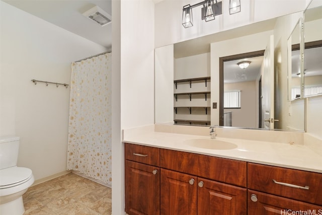 bathroom featuring toilet and vanity