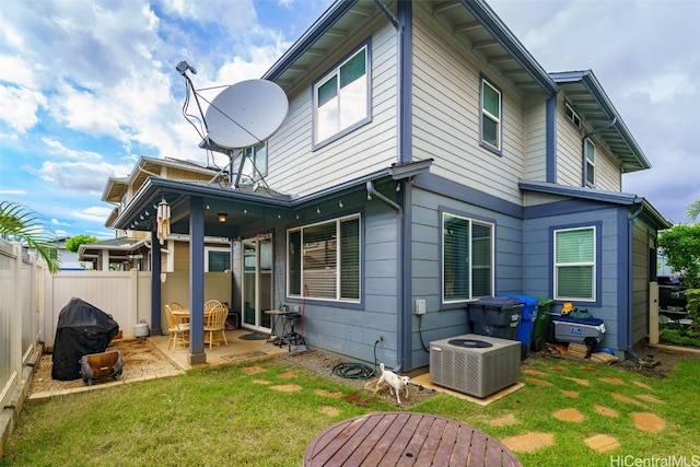 back of house with a patio, central AC unit, and a lawn