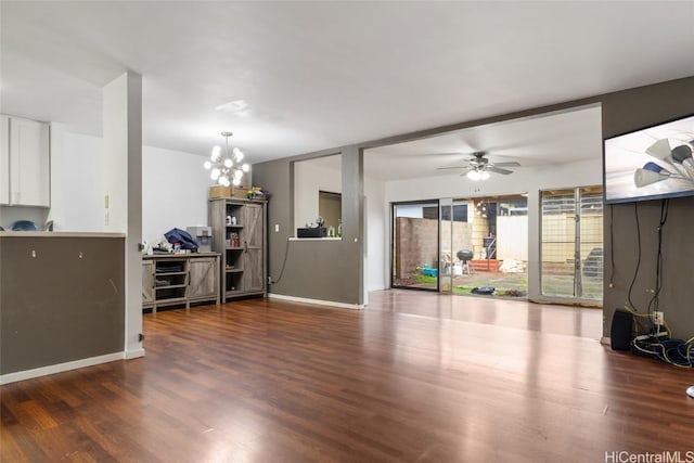 living room featuring dark wood-type flooring and ceiling fan with notable chandelier