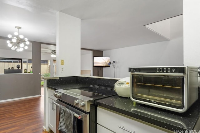 kitchen featuring dark stone countertops, a chandelier, stainless steel electric range, dark wood-type flooring, and white cabinets