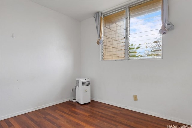 empty room with dark hardwood / wood-style floors