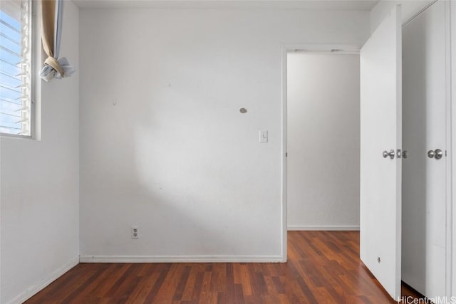 spare room featuring dark hardwood / wood-style flooring