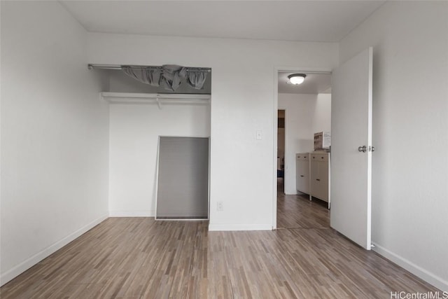 unfurnished bedroom featuring light wood-type flooring and a closet