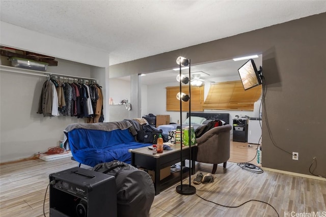 living room with a textured ceiling and wood-type flooring