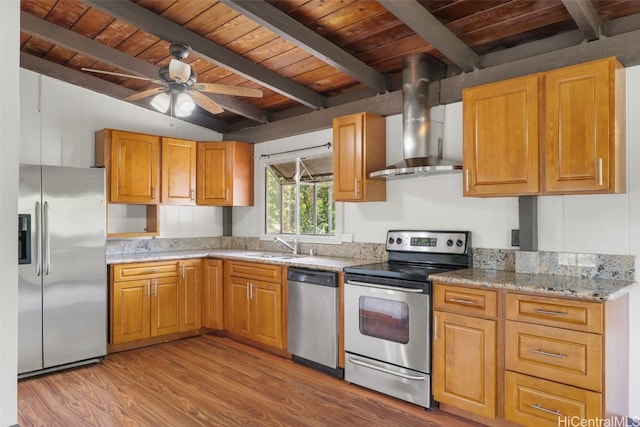 kitchen featuring light hardwood / wood-style floors, stainless steel appliances, ceiling fan, light stone counters, and wall chimney range hood