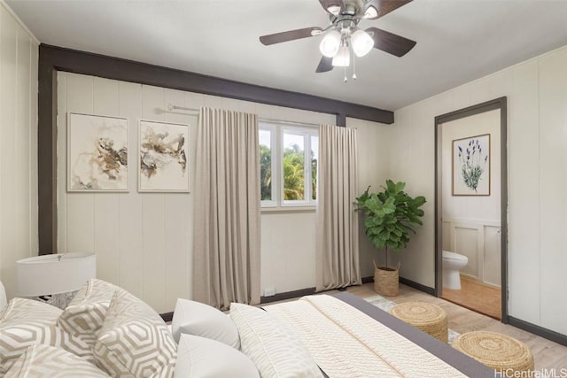 bedroom featuring ceiling fan, light hardwood / wood-style flooring, and ensuite bath