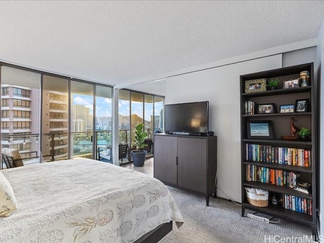 carpeted bedroom featuring a textured ceiling