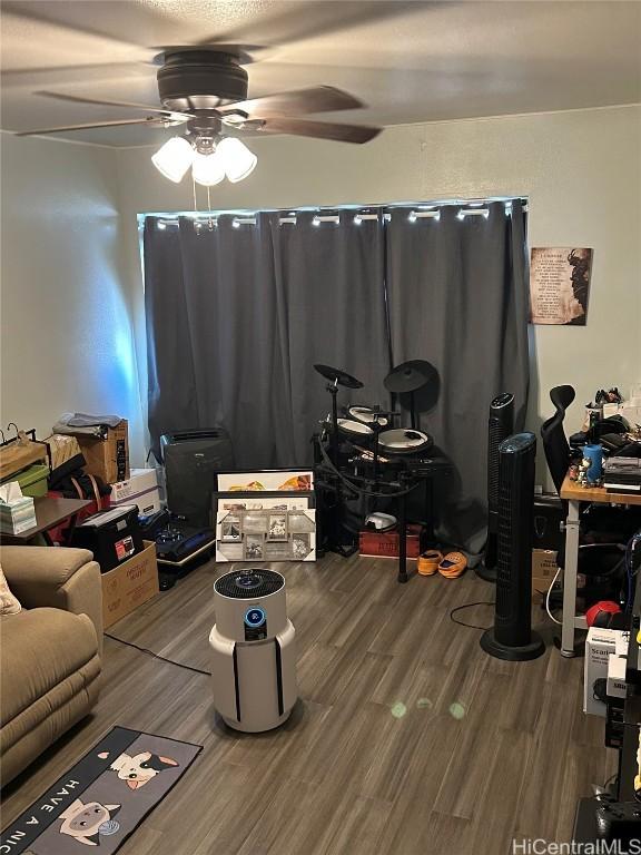 living room with hardwood / wood-style flooring and ceiling fan