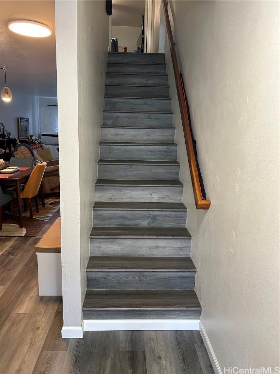 stairs featuring hardwood / wood-style floors