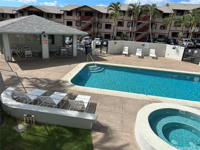 view of pool featuring a patio area and a community hot tub