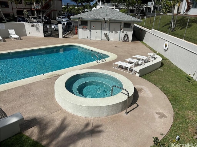 view of pool featuring a patio and a community hot tub