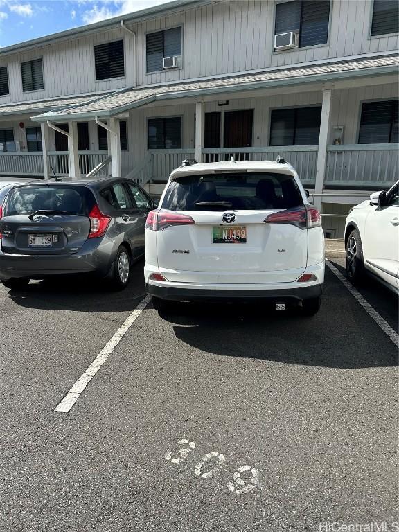 view of parking / parking lot featuring cooling unit