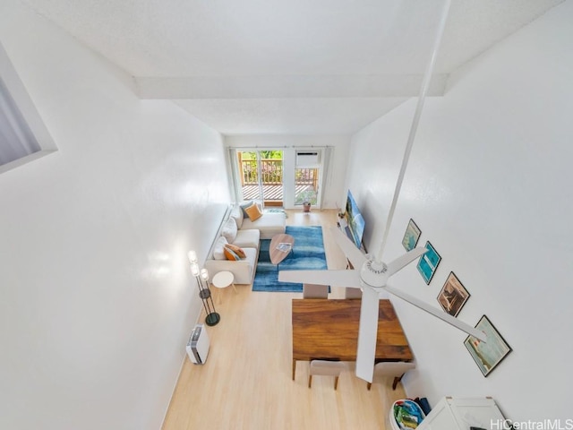 living room with beam ceiling and hardwood / wood-style floors