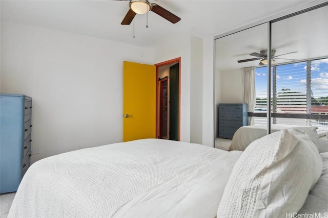 bedroom with ceiling fan and a closet