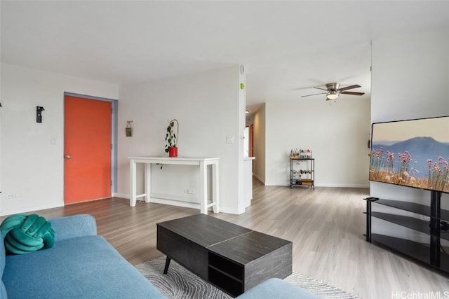 living room with ceiling fan and hardwood / wood-style floors