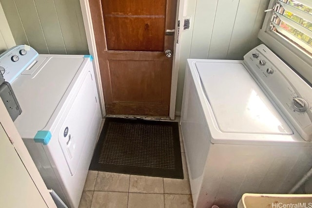 laundry room featuring light tile patterned flooring and washing machine and dryer