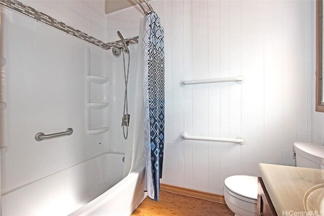 bathroom with shower / bath combo with shower curtain, vanity, toilet, and wood finished floors