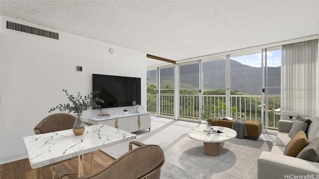 living room featuring expansive windows and a textured ceiling