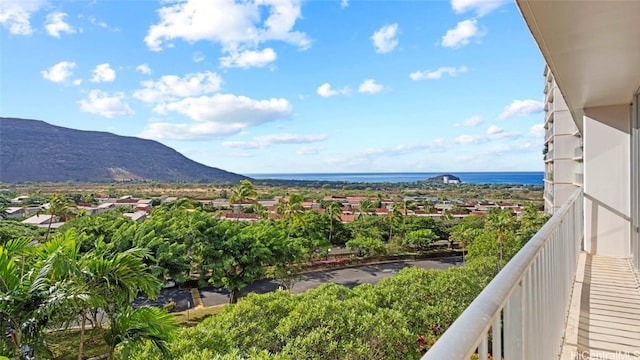 balcony featuring a water and mountain view