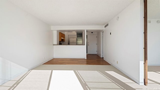 spare room with wood-type flooring