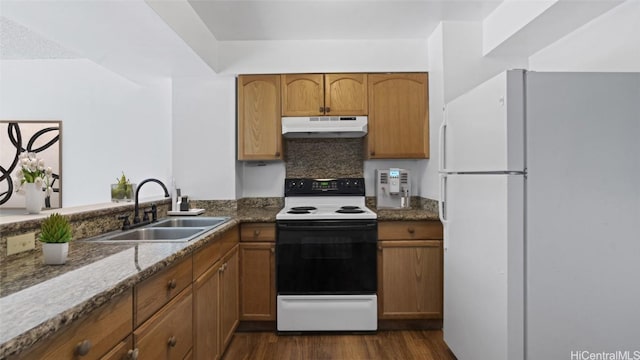 kitchen with decorative backsplash, dark hardwood / wood-style flooring, range with electric cooktop, sink, and white fridge