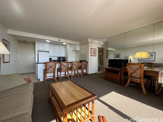 living room with dark colored carpet