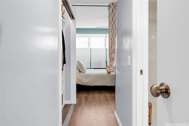 corridor with wood-type flooring